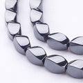 Perles Brins d'hématite synthétique torsion ovale - 9x6 mm